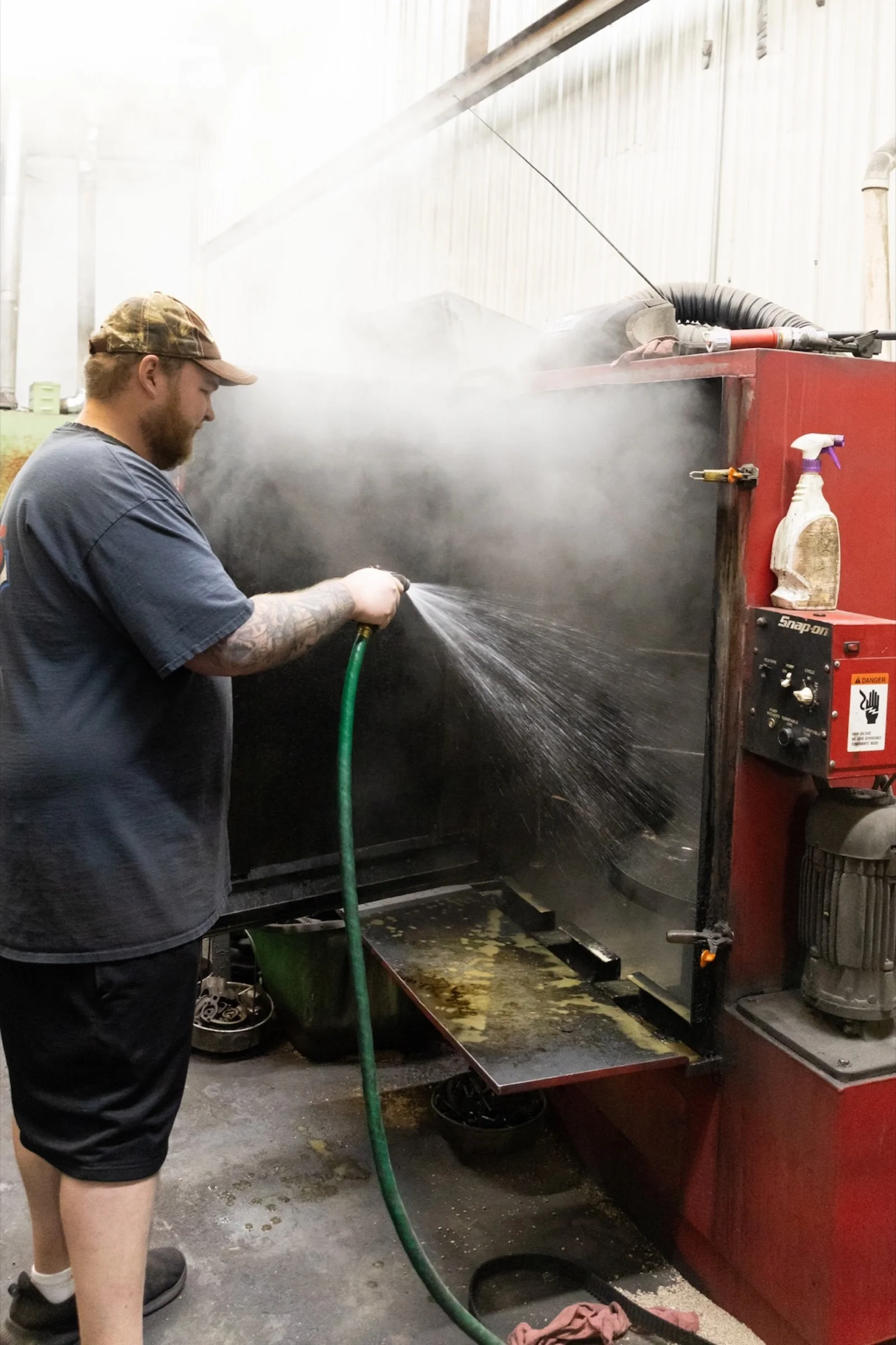 Dakota cleaning engine parts before machining at G&S Machine Shop
