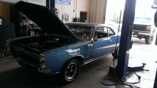 Chevrolet Chevelle classic muscle car in shop for automotive service and engine work