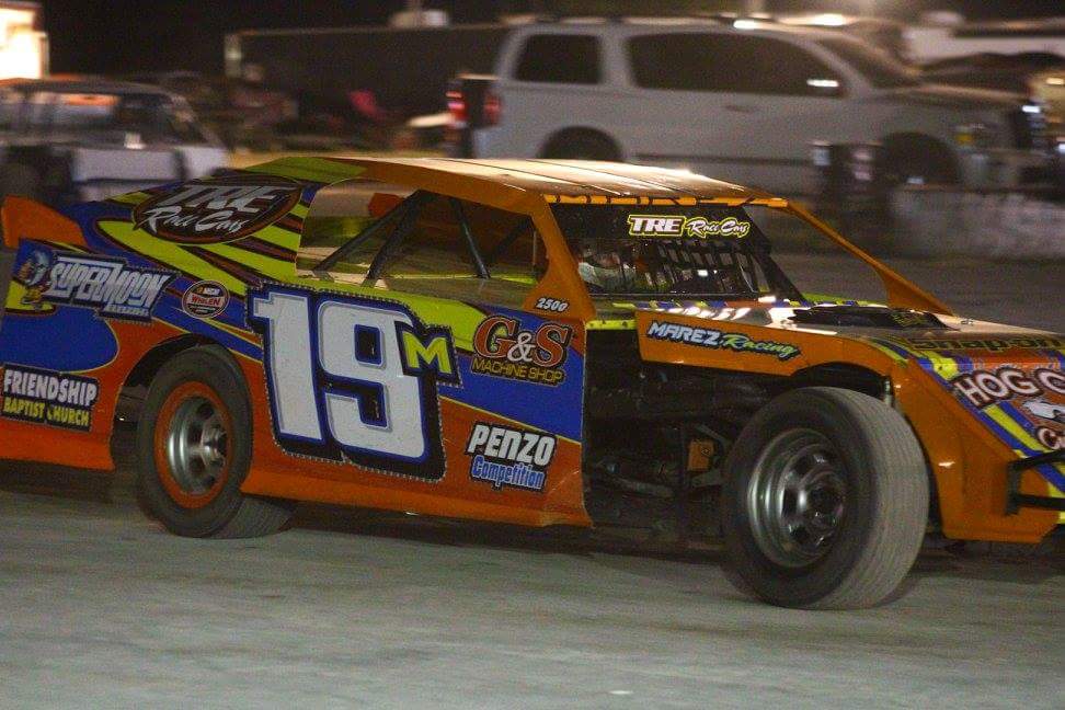 Dirt modified race car sponsored by G&S Machine Shop competing in high performance dirt track racing
