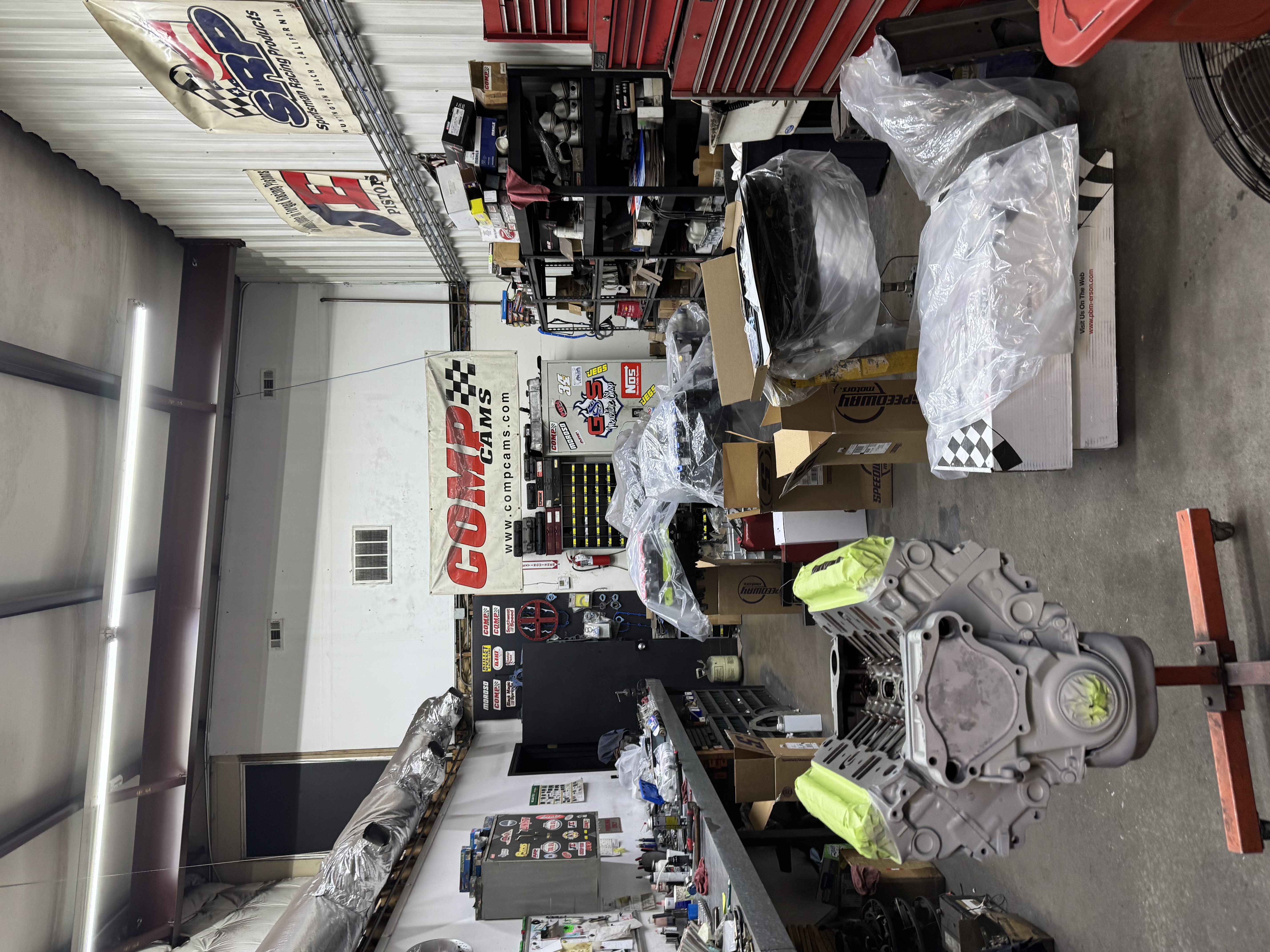 Engine block setup and assembly process inside full-service engine machine shop during rebuild