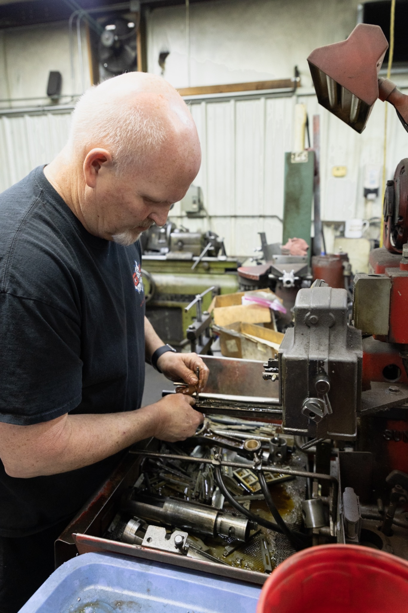 G&S Machine Shop technician resizing engine connecting rods on a precision milling machine during engine rebuild and machining services in Northwest Arkansas