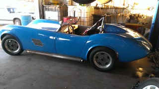 Kellison J5 Roadster custom kit car in shop for automotive service and engine work